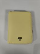 An as new Tumi Belden zip-around passport case, washed yellow (S156544-A871).