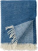 An as new Klippan Yllefabrik velvet throw in lambs wool, Petrol Blue with tassels, tags and wool com
