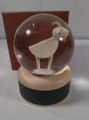 A boxed Loro Piana goat snow globe.