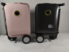 A pre-owned Airwheel Robot SE35 pink with battery and charger suitcase, plus another case only.