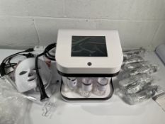 An as new beauty machine with accessories (NO model or serial numbers, possibly Omiskin's?).