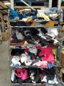 A large quantity of assorted as new and pre-owned clothing in four baskets.