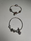Two pre-owned Pandora charm bracelets with nine pre-owned charms.