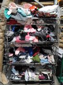 A large quantity of assorted as new and pre-owned clothing in four baskets.