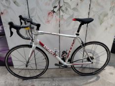 A pre-owned Giant Defy road bike, frame size L, no bike chain (exact model unknown).