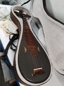 A pre-owned Pipa (Chinese Lute) with spare strings and case (sold as seen).