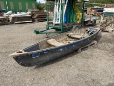 Wooden canoe with oars