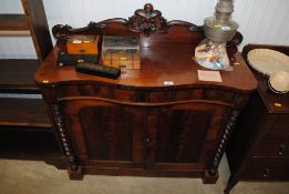 A mahogany serpentine fronted chiffonier