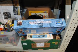 A box containing various board games, cigarette ca
