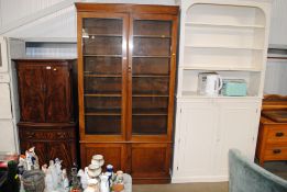 A mahogany display cabinet fitted cupboard base below AF