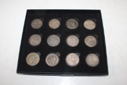 A box containing twelve various silver coloured co