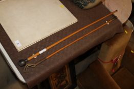 A silver topped swagger stick and a brass handled
