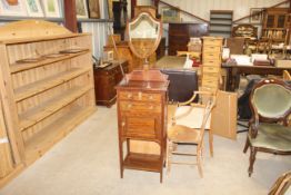 An Edwardian dressing chest with shield shaped bev