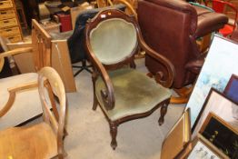 A Victorian scroll upholstered armchair