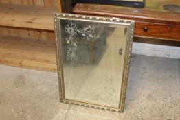 A gilt framed etched glass decorated mirror