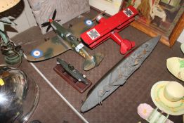 Four wooden models of battleships, submarine and t