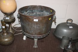 A copper copper flanked by lion mask ring handles