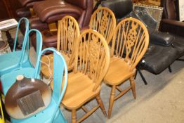 A set of four beech stick and wheelback dining cha