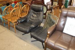A leather upholstered armchair and matching footst
