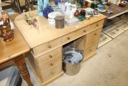 A stripped pine twin pedestal desk