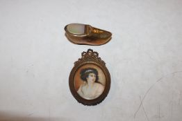 A brass and mother of pearl snuff box in the form