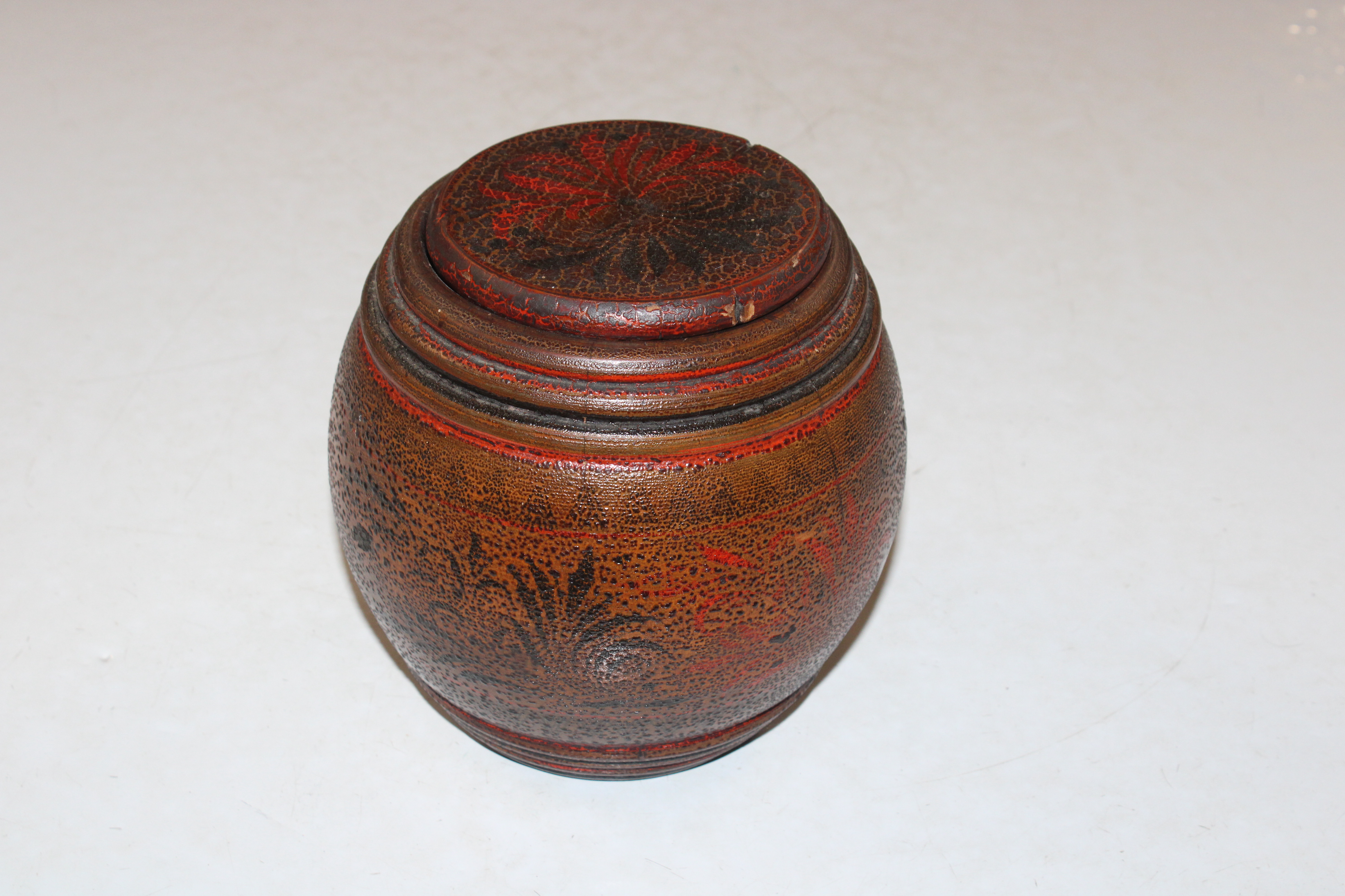 A turned wooden jar and cover