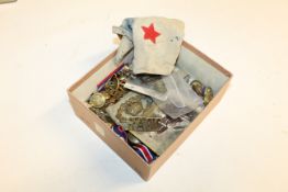 A box containing military badges etc.