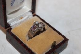 A silver ring set with mother of pearl and semi-pr
