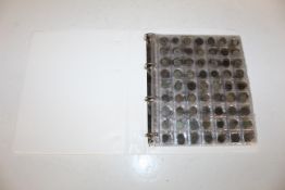 A folder containing Roman coins, vendor reports al