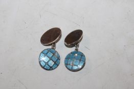 A pair of silver and enamel decorated cuff-links