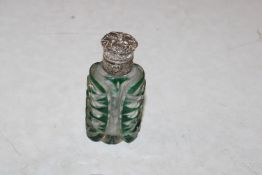 A silver topped green overlaid glass scent bottle