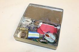A tin containing various medals