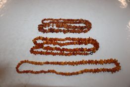 A bowl containing amber and amber coloured bead ne