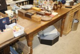 A pine kitchen table raised on turned supports