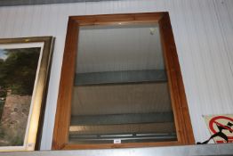 A pine framed wall mirror.