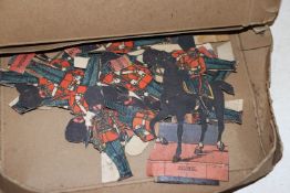 A quantity of paper cut outs of soldiers