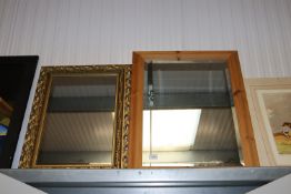 A pine framed bevel edged wall mirror and a gilt framed wall mirror