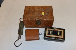 A carved wooden box containing Salter pocket balan