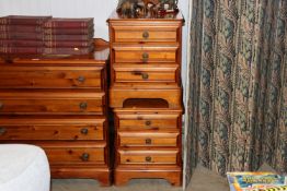 A pair of pine bedside chests fitted three drawers