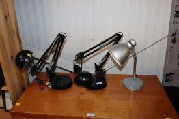 Two Angle Poise style lamps, together with a desk lamp