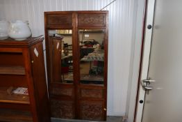 Two Oriental carved wooden mirrored panels