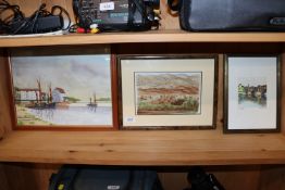 A framed and glazed watercolour study depicting a village, indistinctly signed to bottom right; a
