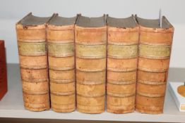 Five volumes Dickens works in pale red leather bin