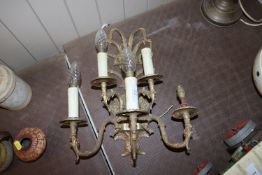 A five light wall sconce with flower head decorati