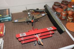 Four wooden models of battleships, submarine and t