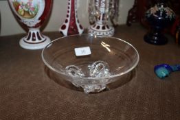 A mid-20th Century glass bowl with horseshoe feet,