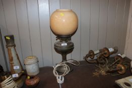 A brass oil lamp and glass shade converted to elec