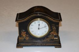 A black lacquered chinoiserie decorated mantel clo