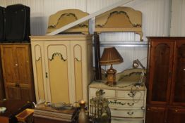 A painted and decorated bedroom suite comprising single door wardrobe, fitted single drawer, a chest