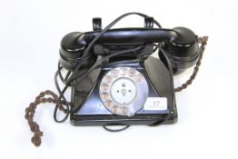 A vintage black rotary dial telephone